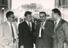 L.t.r.: Witold Lisowski (IAEA Executive Secretary of the conference), Evgueni Piskarev (Scientific Secretary, Institute of Atomic Energy, Russia), Bronislaw Buras (IAEA Coordinating Scientific Secretary) and Claude Etievant (Scientific Secretary, CEA, France) during an informal conversation, seen in front of a window with view to Festung Hohensalzburg at the Europahaus in Salzburg, Austria, September 1961. 
(IAEA Archives/Credit: Photo Ellinger)