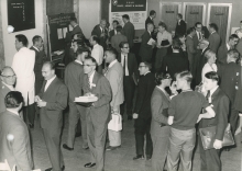 Participants during informal conversation somewhere outside the conference room. Lyman Spitzer, inventor of the stellarator device, can be seen crossing the room holding a book.
(IAEA Archives/Credit: Photo Ellinger)