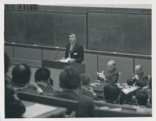 John B. Adams, Director of Culham Laboratory, speaking at the opening of the conference; (right) Sir John Cockcroft, Master of Churchill College, and Henry Seligman, IAEA Deputy Director General. 
(IAEA Archives/Credit: UKAEA, United Kingdom)