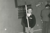 Boy holding a sign, saying: "Mr. PALUMBO to the Registration please! URGENT!". 
Mr. Palumbo was the EURATOM representative to the conference. 
(IAEA Archives/Credit: Photo Ellinger)