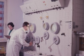 Hans Grasmuk and Olga Milosevic-Golwig, staff members, in front of the hot cell used for the remote handling of radioisotopes at the IAEA laboratory in Seibersdorf. April 1964. Please credit IAEA