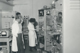 Staff from the Division of Research and Laboratories. Left, Prof Alexandre Sanielevici. Right,  Maria Chino. Background, Andre Gandy. February 1960. Please credit IAEA