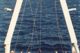 A Kullenberg corer is used to collect sediment cores. The Mururoa Atoll can be seen on the horizon and a buoy upper right. 1996. Please credit IAEA