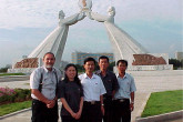 Dr. Yousry Abushady and an inspector of the IAEA with DPRK guides in front of the Reunification Statue in North Korea. (Credit: IAEA) 