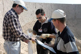 IAEA inspectors take a smear sample from a test range. Photo Credits: Pavlicek/IAEA