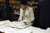 Statements made by Board members are collected and distributed inside the meeting room. (Photo Credit: D. Calma/IAEA)