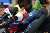 A bustle of microphones from media organizations converging in Vienna to report on the outcome of the IAEA Board Meeting on Iran. (Photo Credit: D. Calma/IAEA)