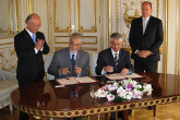 In Monaco, Massoud Samiei, Director, IAEA Programme of Action for Cancer Therapy (PACT), graciously accepted a donation of #8364;175 000 to fund the Agency's work to assist Niger in establishing a national cancer control programme.  Mr. Samiei (seated left) and Mr. Frank Biancheri, Government Counsellor for External Relations and International Financial Affairs of Monaco, signed the agreement in the presence of IAEA Director General Yukiya Amano and H.S.H. Prince Albert. (Photo: D. Sacchetti/IAEA)