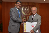 India's Ambassador Rajiva Misra hands over to IAEA Director General Yukiya Amano the instrument of ratification of India's Additional Protocol with the IAEA. IAEA, Vienna, Austria. 25 July 2014.