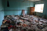 Backstage at the community theater, costumes and props lie scattered on the floor, having sat for nearly a quarter century.