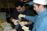 At a machine tool factory, IAEA inspectors take smear samples. Photo Credits: Pavlicek/IAEA