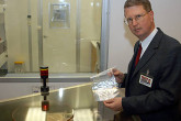 Mr. David Donohue shows Iraq samples prepared for screening. Photo Credits: D. Calma/IAEA 19 December 2002