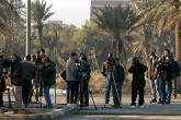 Journalists waiting for inspectors to leave their Baghdad headquarters. Photo Credits: Pavlicek/IAEA