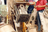 Inspectors examine the remains of Electro Magnetic Isotope Separation (EMIS) equipment that had been salvaged from a bombed building. T Photo Credits: Action Team 1991-1998/IAEA
