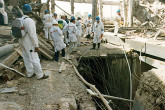 Inspectors assess the ruins of a facility used to produce highly enriched uranium.Photo Credits: Action Team 1991-1998/IAEA