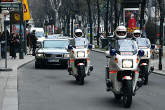 The UN motorcade passes through Vienna's downtown area.