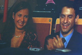 The smiling faces of Dr ElBaradei's son Mostafa and daughter Laila appear on two huge screens as they watch the concert.