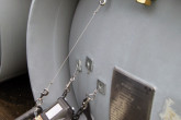 A handheld gamma ray detector system is used to measure the enrichment of uranium in a metal cylinder.