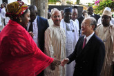 IAEA Director General Yukiya Amano is welcomed by the personal assistant to Nigeria's first Lady at the international cancer centre, Abuja. (Photo: A. Sotunde)