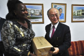 IAEA Director General Yukiya Amano  presents a cancer drug donation to the university of Enugu teaching hospital representative in Abuja. (Photo: A. Sotunde)