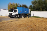Truck with ISO transport container containing the IIN-3M Foton rector’s irradiated liquid HEU fuel is leaving the site of the Radiation and Technological Complex in Tashkent, Uzbekistan. After draining the HEU fuel from the reactor core, it was safely and securely placed into transport canisters, which were then loaded carefully onto a SKODA VPVR/M spent fuel shipment container. That container is inside the standard, blue transport container on the truck. (Photo: S. Tozser/IAEA)