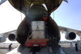 The over-package rolls into the plane on the back of the truck. (Photo: S. Tozser/IAEA) 