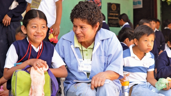 A field worker discusses the benefits of good nutrition at an urban primary school in Guatemala